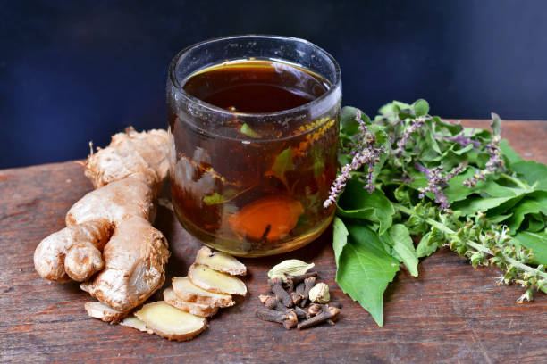 A cup of Tulsi (Holy Basil) tea with fresh Tulsi leaves